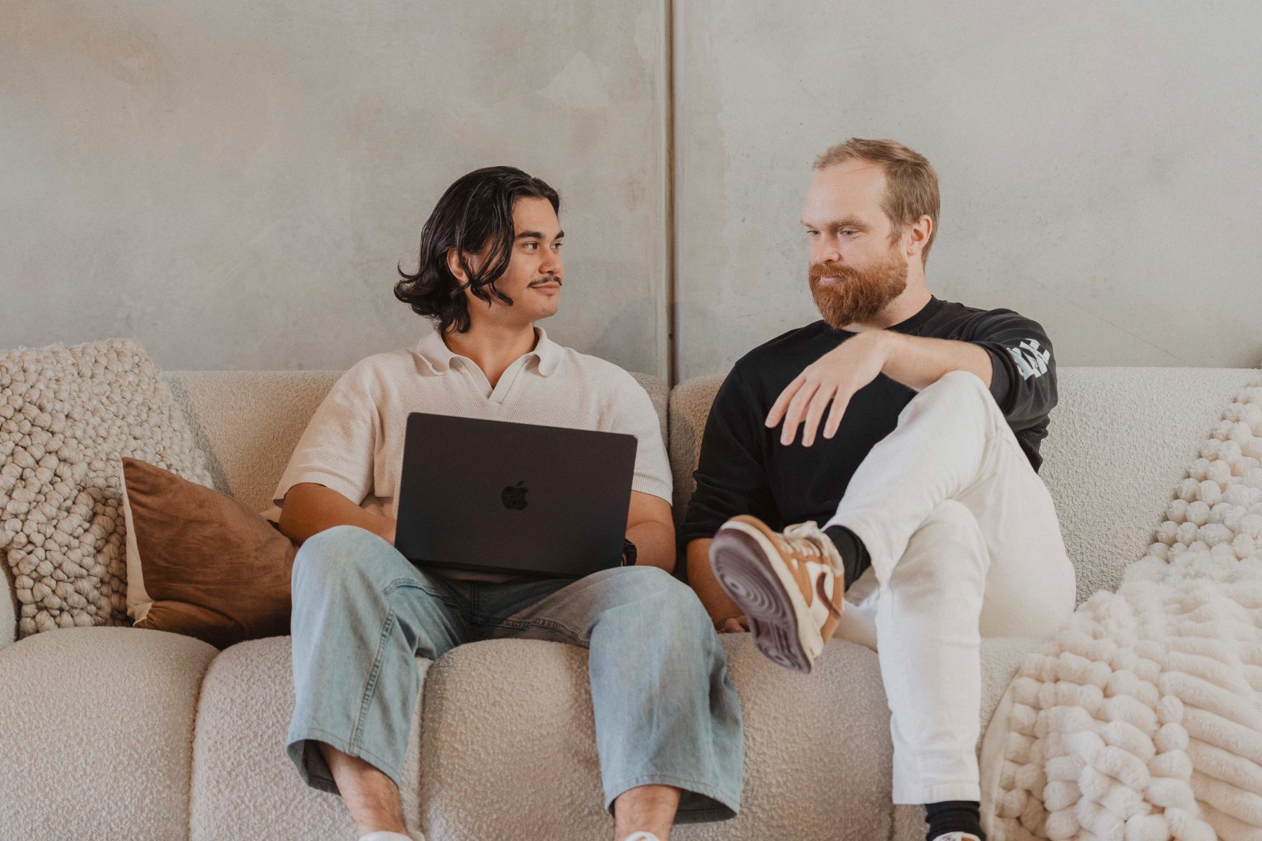 Two members talking on the couch at Gravitate Space