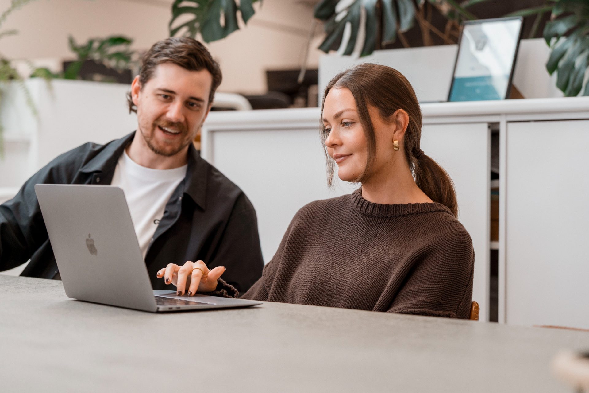 Two members working together at a laptop inside the Gravitate Space warehouse